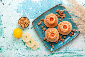 top view delicious cakes with cookies sweet nuts light blue desk bake biscuit cake sweet sugar nut