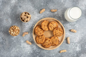 cookies with organic peanuts glass milk marble table