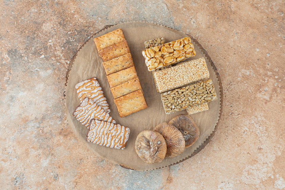 wooden board full sweet cookies peanut brittles